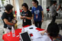 Volunteers helping a resident with registration.